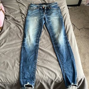 Buckle black skinny jeans